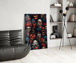 grinning dark carnival clown faces glass wall art leaning beside a dark leather sofa