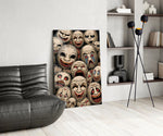 stacked sepia theatre masks glass wall art leaning beside a dark leather sofa