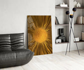 a radiant golden sunburst glass wall art leaning beside a dark leather sofa