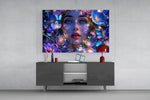 a blue-eyed woman among glowing flowers glass wall art displayed above a console in a designer interior