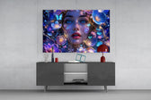 a blue-eyed woman among glowing flowers glass wall art displayed above a console in a designer interior