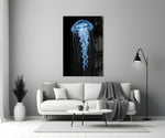a blue jellyfish in black water panel bringing character to a minimalist living room wall