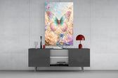 an iridescent butterfly over pastel flowers glass wall art displayed above a console in a designer interior