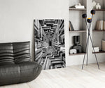 a black and white timber corridor in perspective glass wall art leaning beside a dark leather sofa