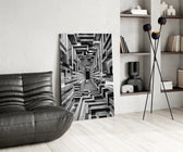a black and white timber corridor in perspective glass wall art leaning beside a dark leather sofa