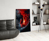 a cupped hand holding a burning red candle glass wall art leaning beside a dark leather sofa