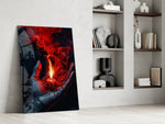 a cupped hand holding a burning red candle panel resting in a shelving niche in a modern interior