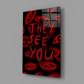 a red handwritten warning over watching eyes glass wall art angled to show the polished tempered glass panel