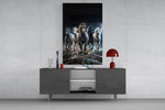 a herd of horses galloping through a storm glass wall art displayed above a console in a designer interior
