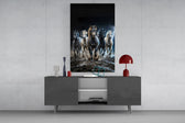 a herd of horses galloping through a storm glass wall art displayed above a console in a designer interior