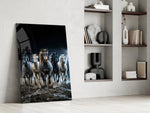a herd of horses galloping through a storm panel resting in a shelving niche in a modern interior