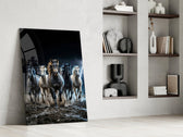 a herd of horses galloping through a storm panel resting in a shelving niche in a modern interior