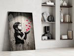 stencil girl releasing red paper cranes panel resting in a shelving niche in a modern interior