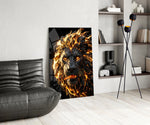 a roaring lion with a molten lava mane glass wall art leaning beside a dark leather sofa