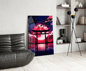a torii gate before a crimson moon glass wall art leaning beside a dark leather sofa