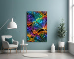 rainbow neon ginkgo leaves with dewdrops glass wall art styled above an armchair in a reading corner