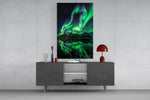 a green aurora over mirrored peaks glass wall art displayed above a console in a designer interior