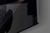 Close-up detail of the crimson shaft of light spilling across the floor on the glass surface