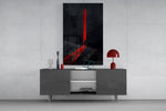 a cloaked figure at a red doorway glass wall art displayed above a console in a designer interior