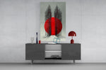 crimson sun behind bare poplars glass wall art displayed above a console in a designer interior