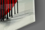 Close-up detail of the thread-thin trunks crossing the red disc on the glass surface