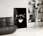 coffee energy formula humor glass wall art leaning beside a dark leather sofa