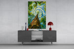 swirling sky through a treetop canopy glass wall art styled in an atmospheric room setting