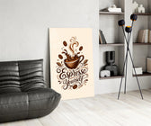a splashing espresso cup with lettering glass wall art leaning beside a dark leather sofa