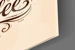 Close-up detail of the swirling steam, tumbling coffee beans, and ornate flourishes on the glass surface