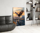 a bald eagle over autumn mountains at sunset glass wall art leaning beside a dark leather sofa