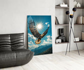 a bald eagle before a bright sunburst glass wall art leaning beside a dark leather sofa
