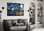 a swirling starry night over a city skyline glass wall art styled above an armchair in a reading corner