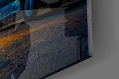 Close-up detail of the swirling cobalt sky and the warm glow of the van windows on the glass surface