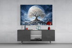 a white blossom tree beneath a full moon glass wall art styled in an atmospheric room setting