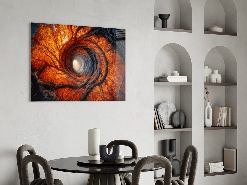an autumn forest spiralling into a tunnel of light glass wall art leaning beside a dark leather sofa