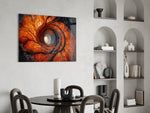 an autumn forest spiralling into a tunnel of light glass wall art leaning beside a dark leather sofa