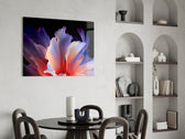 an abstract flower with translucent petals glass wall art leaning beside a dark leather sofa