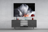 an abstract white flower on black glass wall art styled in an atmospheric room setting