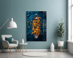 a wooden rowboat full of sunflowers on dark water glass wall art styled above an armchair in a reading corner