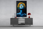 a blue-skinned woman crowned with sunflowers glass wall art styled in an atmospheric room setting