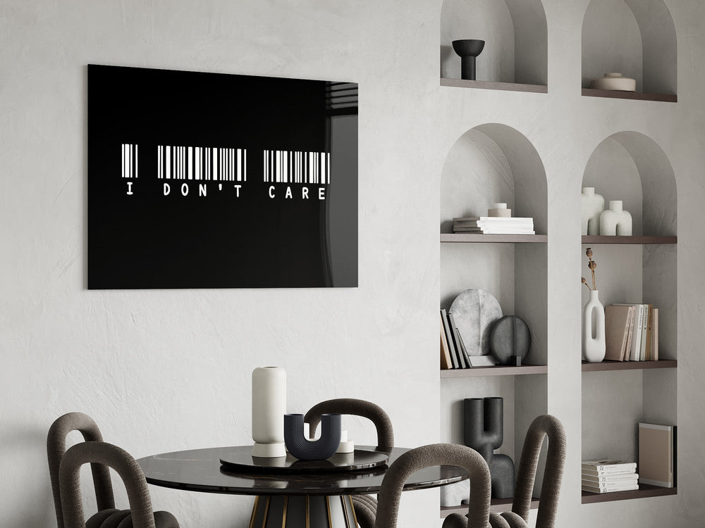 I dont care barcode statement glass wall art leaning beside a dark leather sofa