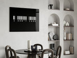 I dont care barcode statement glass wall art leaning beside a dark leather sofa