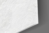 Close-up detail of the glossy black pawn and its crowned shadow on the textured white ground on the glass surface