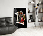 skull king and masked queen cards glass wall art leaning beside a dark leather sofa