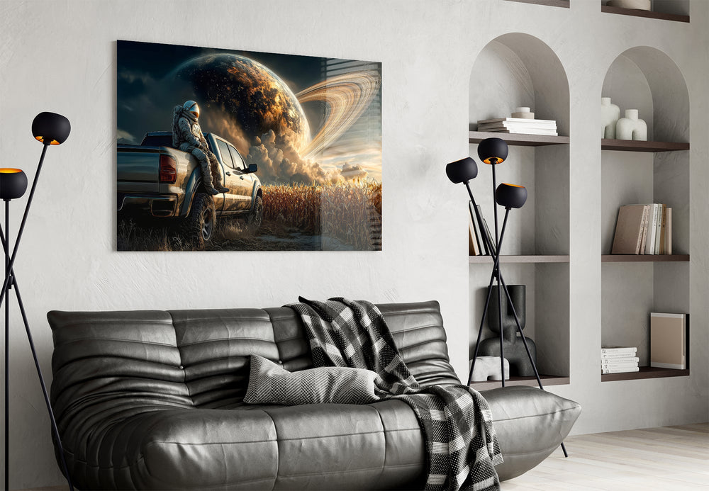 astronaut resting against a pickup truck glass wall art styled above an armchair in a reading corner