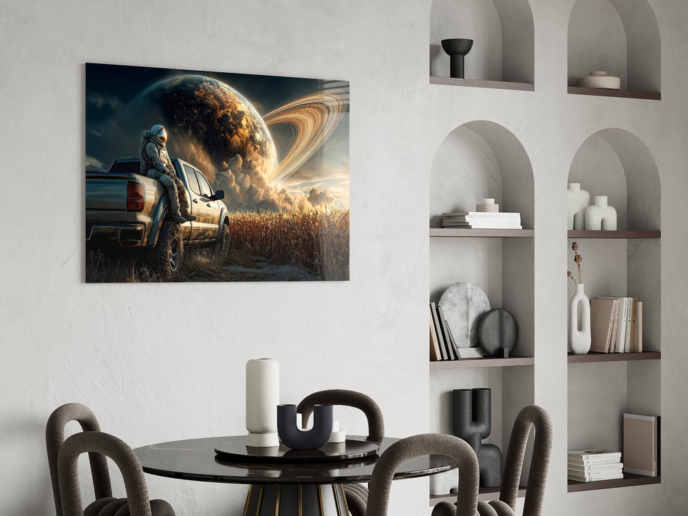 astronaut resting against a pickup truck glass wall art leaning beside a dark leather sofa