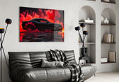 black muscle car in crimson smoke glass wall art styled above an armchair in a reading corner