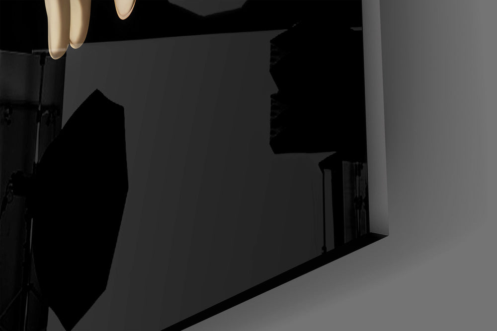 Close-up detail of the near-touching fingertips and glowing loading icon on the glass surface