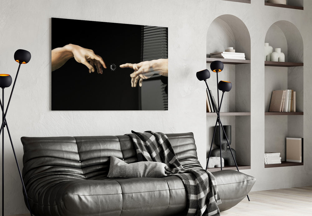 two reaching hands with a loading spinner glass wall art styled above an armchair in a reading corner