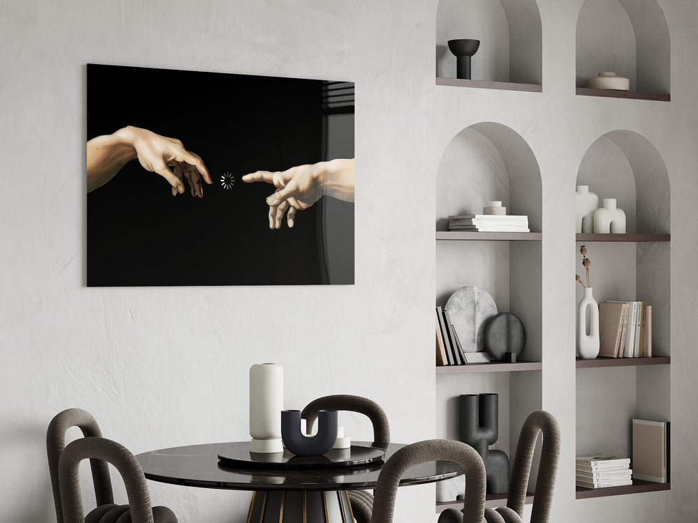 two reaching hands with a loading spinner glass wall art leaning beside a dark leather sofa